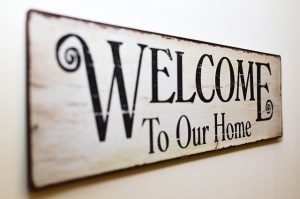 A wooden sign that says "Welcome to our home""
