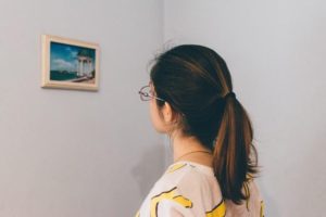 Woman looking at painting 