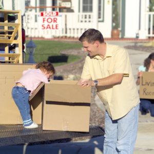 a man and his child with moving boxes